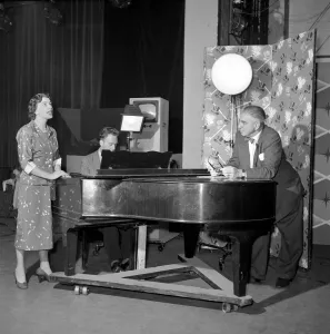 TV presenter Fred Wilby seen here beside the piano in the studios of Midland TV