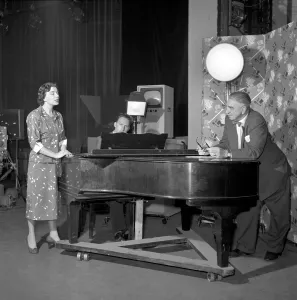TV presenter Fred Wilby seen here beside the piano in the studios of Midland TV