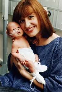 TV presenter Jackie Bird holding her baby Jacob March 1995
