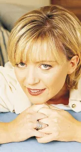 TV presenter Kirsty Young lying with chin on clasped hands