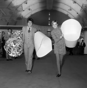 Exhibitions Prints: Twiggy with her manager, Justin de Villeneuve carrying some of the paper chairs