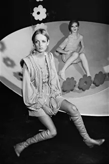 Sculpture Prints: Twiggy sitting beside waxwork of herself wearing mini skirt and knee high boots