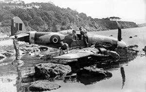 01438 Collection: A Typhoon makes a pancake landing, on the edge of a rock strewn shore near Torquay in