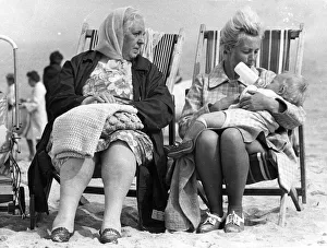A typical British summer holiday scene - a family wrapped up against the cold in