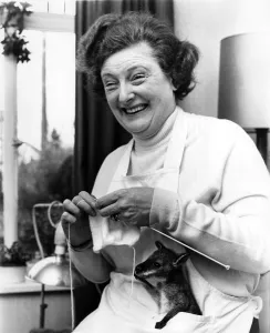 Knitting Prints: An un-named woman knits as a baby Wallaby keeps warm in her apron pocket at Tycross Zoo