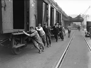 00278 Prints: Undergraduates at Dover shunting luggage vans on to the boat train on the 8th day of