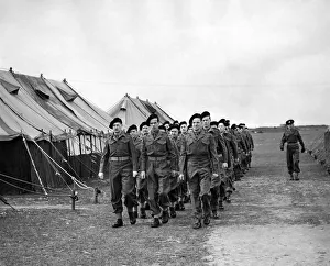 00059 Prints: Back in uniform, and back in line. A squad of newly uniformed Z men march past a line of