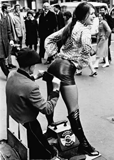 Weird Prints: Unusual Picture of Czech model Dana Mala having her hot pants polished by a bootblack