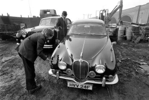 Unusual / Suit / Bowler Hat: Man Scraps Jaguar Car: On the other hand, Sales Director Mr