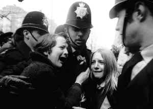 Emotional Prints: Upset Beatles fans crying because Paul McCartney got married are led away by police