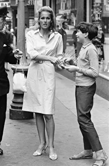 Ursula Andress, Swiss actress, signs autograph for young admirer