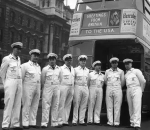 00099 Prints: USA London Bus Tour. Bus crew members lined up in front of an RT London Bus