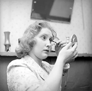Cosmetics Prints: Valerie Pearce seen here applying masscara getting ready for a night on the town