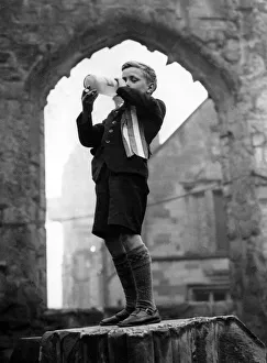 00112 Prints: After the VE Day service in the cathedral ruins a youngster bedecked with a rosette