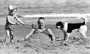 Core36 Prints: Vera Tomlinson gets buried in the sand by little Kate Argent