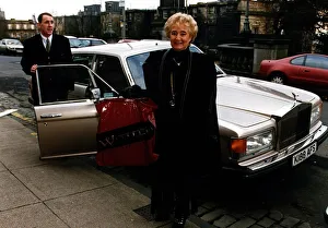 Jg Scan Prints: Vera Weisfeld standing beside Rolls Royce car holding plastic bag Weisfelds store