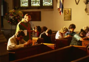 00027 Prints: Vicar in church with people praying in Hungerford August 1987