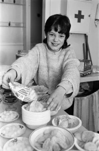 Victoria Gibson helps prepare for an annual tea party for some 80 pensioners at Parkwood