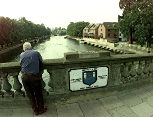 Depressed Prints: A view from the Workman Bridge in Evesham. Man standing on a bridge over the River Avon