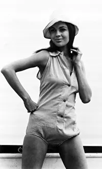 1960s Fashion Prints: Virginia North modelling beach fashion - a one piece outfit with button detail