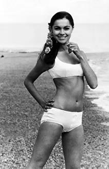 Holiday Prints: Virginia North modelling a bikini on a beach staning with her hand on her hip smiling