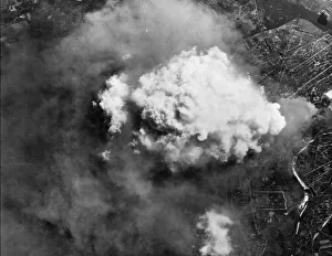 Usaaf Prints: A Volcano of smoke spouts up from Hanovers sprawling tyre factories after a heavy