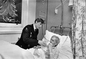 Ward Prints: Volunteer Labour in Hospitals. 15 year old Robert Newport helping the Nurse in charge of