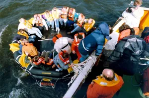 Volunteers clamber into the new life raft during a mock evacuation of the cross Tyne