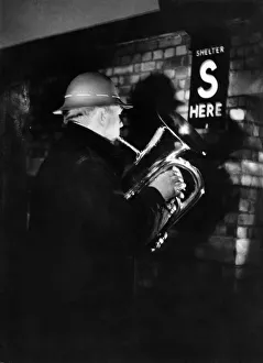 00113 Prints: W. G. Dodge of the Wood Green Silver Prize Band plays Christmas Carols by moon light in