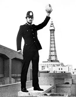 Places Prints: Wade Dooley rugby Union Player and policeman holding a rugby ball as he stand in front of