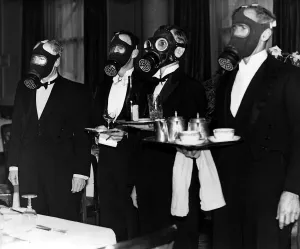 Gas Masks Prints: Waiters wearing gas masks during an exercise at the Royal Station Hotel