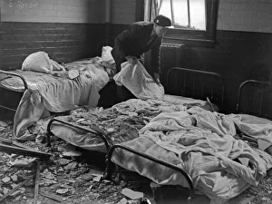 A warden searches the damaged wards of Erdington House hospital following a raid