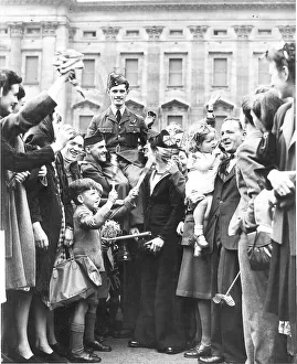 Warrant Officer Westerman is carried shoulder high from Buckingham Palace after being