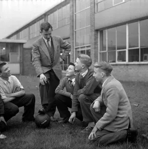 00238 Prints: Warren Bradley of Manchester United with some of the boys at the school in Manchester