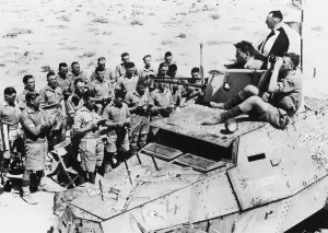 Warship in Western Desert. An armoured car congregation singing hymn at church of
