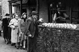 Wartime food rationing - people queuing up for their shopping - bread rationing