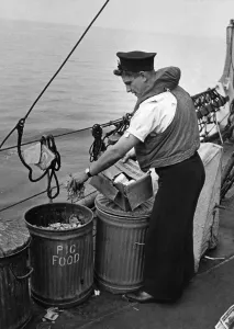 Recycling Prints: Nothing is wasted at Sea. Picture shows seaman placing waste in salvage tins so familiar