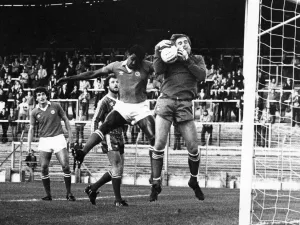 ) watches as City defender Gary Bennett challenges for the ball with Hereford United
