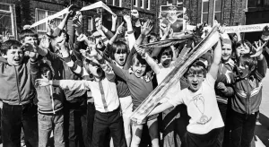 Wayne Ashe (right) leads the cheers from the Loyal Liverpool fans at Anfield Junior Boys