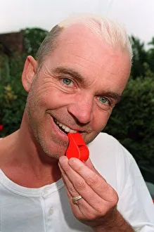 Wayne Dobson TV Magician blows a whistle in the garden of his home Dbase