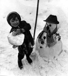 Weather - A snowman dressed in dads hat and scarf gets a pounding from this