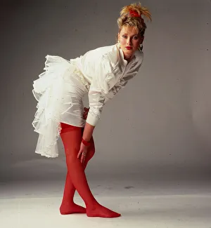 Bridal Prints: Wedding dress fashion, October 1987 Model wearing white satin dress with mini skirt