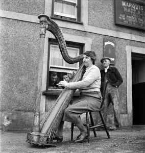 Harp Prints: Welsh Harpist Marry Anne Jones seen here performing in the street. March 1952 C1118