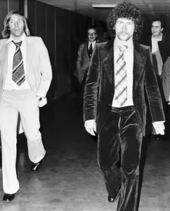 Afro Prints: West German footballer Paul Breitner on his way through Heathrow Airport with fellow