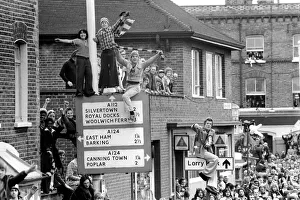 Success Prints: West Ham fans try to get a good view above the crowds during the West Ham victory parade