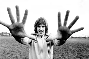 West Ham goalkeeper Phil Parkes shows his large hands to the camera