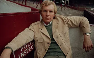 West Ham United footballer Bobby Moore modelling a belted raincoat at Upton park