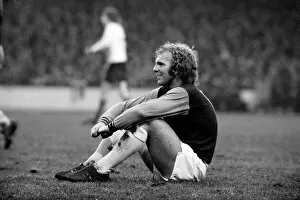 Images Dated 6th January 1973: West Ham vs. Liverpool: Bobby Moore takes a rest during an injury to a Liverpool player