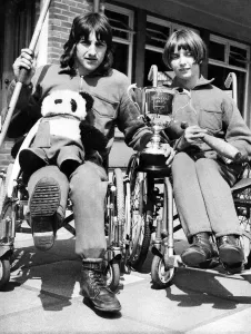Disabled Prints: Two wheelchair champions from the Percy Hedley School in Newcastle show off the cup which