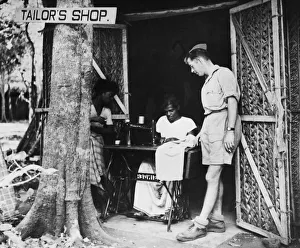 Seamstress Prints: While-U-Waits the tailors shop at an R. A. F. station in Ceylon. 17th May 1943